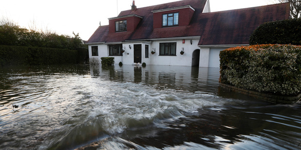 Water overflowing from the River Thames floods a house at Wraysbury, England. Photo / AP