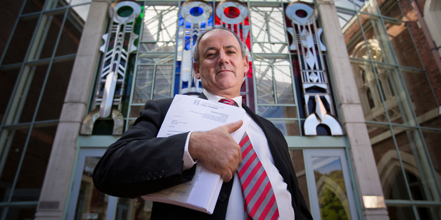 Fair Play on Fees lawyer Andrew Hooker outside the High Court in Auckland with lawsuit documents against ANZ Photo / Greg Bowker.