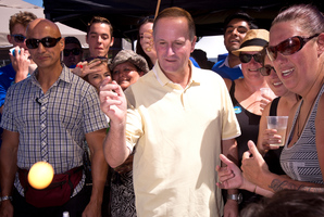 Prime Minister John Key plays a game of beer pong during his visit to the Big Gay Out. Photo / Dean Purcell