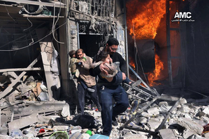 Men help survivors out of a destroyed building after a Syrian forces warplanes attacked in Aleppo, Syria. Photo / AP/Aleppo Media Center (AMC)