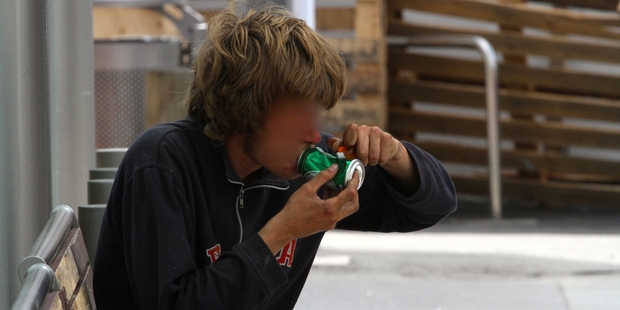 A young male is seen smoking a substance from a can at the bus stop on Willow St. Photo/Richard Moore