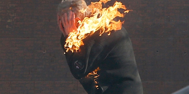 A protester is engulfed by flames during clashes with riot police in the capital Kiev.