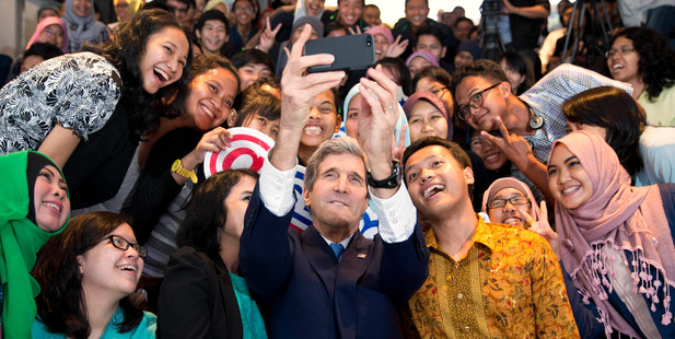 US Secretary of State John Kerry takes with a group of students before delivering a speech on climate change. Photo / AP