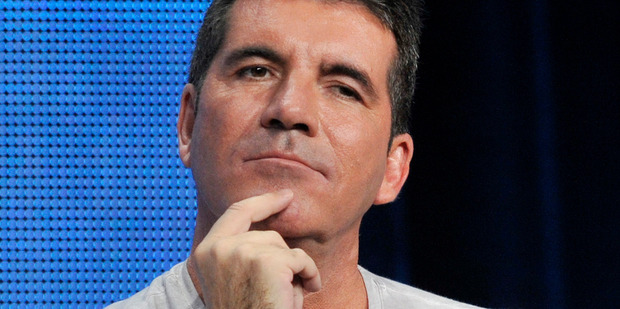 Simon Cowell has revealed the first photos of his newborn son on Twitter.Photo/AP