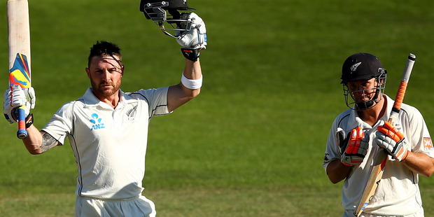 Brendon McCullum of New Zealand celebrates his century (L) as BJ Watling (R) looks on during day three of the 2nd Test match between New Zealand and India. Photo / Getty Images.