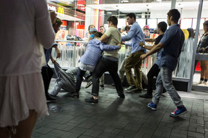 Young men scuffle outside McDonalds, Britomart. Photo / Michael Craig