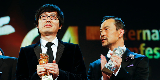 Director Diao Yinan, left, with the Golden Bear for Best Film and actor Fan Liao, right, with the Best Actor Silver Bear for the film 'Black Coal, Thin Ice'. Photo / AP