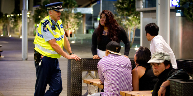Inspector Gary Davey speaks to young people on Fort Street in the early hours of Thursday morning. Police are showing a heavy presence since changes in alcohol law came into place. Photo / APN