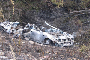 The remains of a car which rolled down a bank and burst into flames. Photo / Lucy Ibbotson