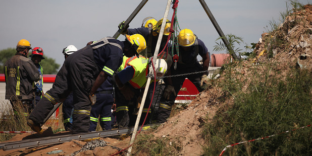 Emergency rescue workers attempt to free trapped illegal miners at a disused gold mine shaft near, Benoni, South Africa. Photo / AP