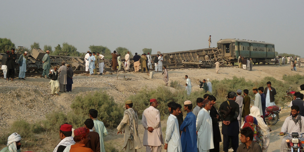 Pakistanis gather at the site of the deadly bomb blast. Photo / AP