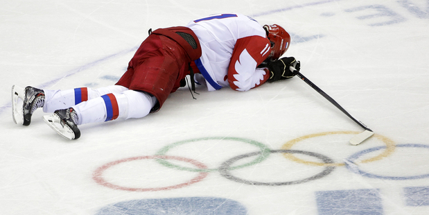 Russia forward Yevgeni Malkin lies on the ice in the closing minutes of the third period in men's quarterfinal hockey game against Finland. Photo / AP