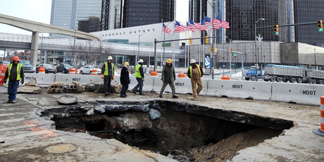 Work crews examine a 4m-deep sinkhole that opened up in downtown Detroit in January 2014. Photo / AP