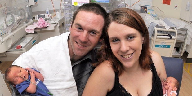 Matamata jockey Michael Gibbs-Manssen and partner Mandy Abraham hold newborn triplets from left, Damien, Viola and Maia. Photo / Waikato DHB