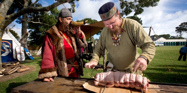 Kiwi Norsemen Franush Bloodaxe, Frank Kirkham, left, and Griff prepare the meat at the Howick Military Tattoo.