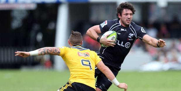 TJ Perenara of the Hurricanes looks to tackle Ryan Kankowski of the Sharks. Photo / Getty