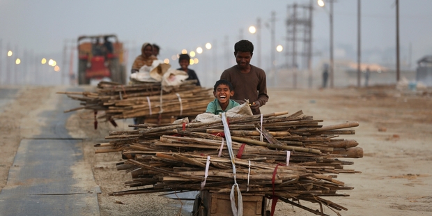 Indians head for the confluence of the Yamuna and Ganges Rivers during the annual
traditional fair of Magh Mela in Allahabad. Photo / AP