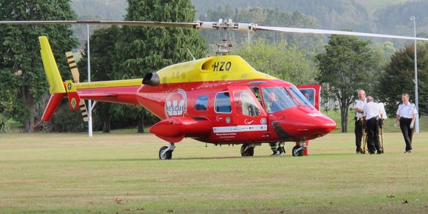 A patient is loaded into the Westpac Rescue helicopter on Thursday morning at Waihi's Morgan Park