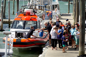 The coastguard assist people back to Westhaven after the Dolphin charter boat they were on started to sink in the Waitamata Harbour. Photo / Dean Purcell.