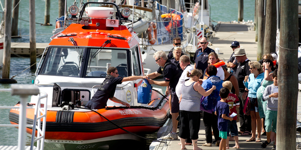 The coastguard assist people back to Westhaven after the Dolphin charter boat they were on started to sink in the Waitamata Harbour. Photo / Dean Purcell.