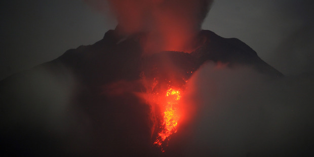 Mount Sinabung spews lava and gas during an eruption as seen from Jeraya, North Sumatra. Photo / AP