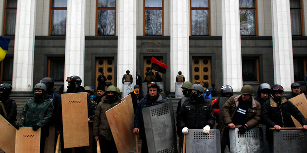 Anti-government protesters stand guard in front of Ukraine's Parliament in Kiev - they are now in control. Photo / AP