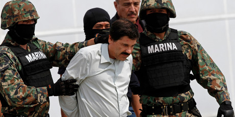Joaquin Guzman is escorted to a helicopter in handcuffs by Mexican navy marines. Photo / AP