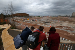 Feb 2014 photo of people taking a look at the construction site in Queen Elizabeth Olympic Park in east London. The Games' Velodrome is seen left. Photo / AP