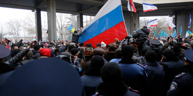 Pro-Russian demonstrators wave Russian flags during a protest in front of a local government building in Simferopol, Crimea, Ukraine. Photo / AP