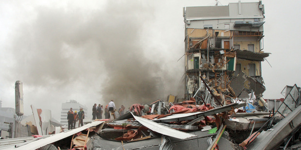 Police and volunteers work to rescue people trapped in the collapsed CTV building. Photo / APN