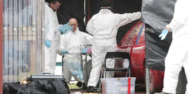 Members of the police Clan Lab Team and Environmental and Scientific Research scientists take samples from a methamphetamine laboratory found in a Whakapara house.