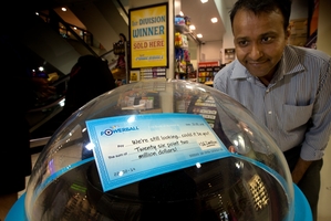 Nilesh Shah owns Willy Wonka where the ticket was sold. The shop has been decked out with signs to get people to check their tickets. Photo / Brett Phibbs