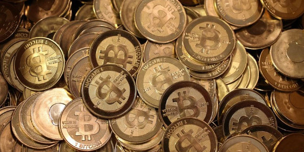 Pictured - physical representations of the popular virtual currency Bitcoins. A major exchange specialising in bitcoins has just gone bust. Photo / AFP