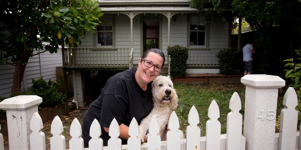 An excited Krista Strong outside her Ponsonby villa with Dudley, her poodle-golden retriever cross. Photo / Dean Purcell