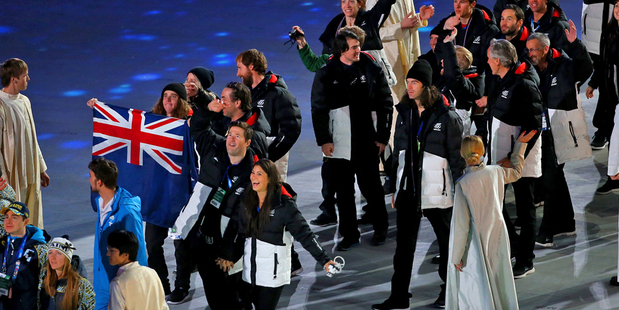 Jossi Wells, left, leads the New Zealand team into the closing ceremony at the Sochi Winter Olympics. Photo / Getty
