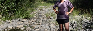 DRIED OUT: Vanessa Tipoki stands in the Tauanui River, where water levels have plummeted this summer. The river is normally knee-high deep in summer.