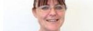 Offensive cake-maker Karen Hammond has been awarded more than $168,000 by NZCU.