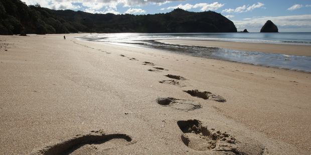 Footprints in the sand on the foreshore of stunning New Chums Beach on the Coromandel Peninsula. Photo / Alan Gibson
