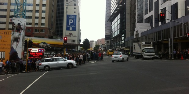 Crowds wait in the street after the building was evacuated. Photo / NZME.