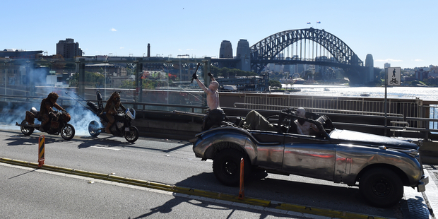 Mad Max: Fury Road film a promo on the Cahill Express against the backdrop of the Sydney Harbour Bridge in Sydney. Photo / AAP ONE