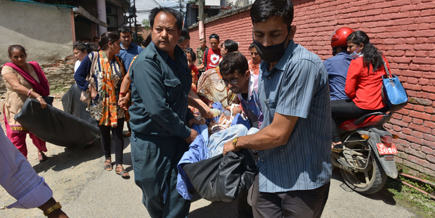 Nepalese patients are carried out of a Kathmandu hospital building as a 7.3 magnitude earthquake hits the country. Photo / Getty Images