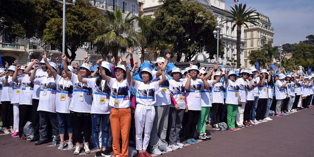 Employees of Chinese company 'Tiens' attend a parade on the Promenade des Anglais in Nice. Photo / AP