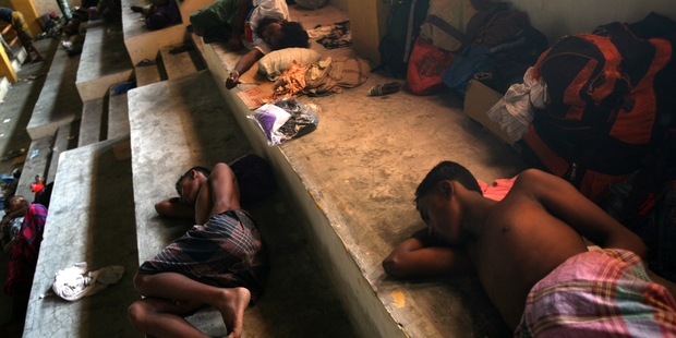 Ethnic Rohingya youths sleep inside a shelter. Photo / AP