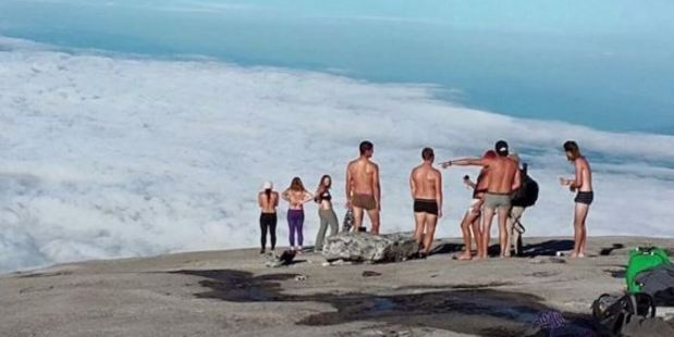 The group of people who undressed and posed for photos on Mount Kinabalu. Photo / via YouTube / Emil Kaminski