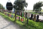LOST SOLES: A fence of jandals at Mauao has been taken down after complaints by the public. PHOTO/JEANNIE OVERALL LOST SOLES: A fence of jandals at Mauao has been taken down after complaints by the public. PHOTO/JEANNIE OVERALL