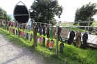 LOST SOLES: A fence of jandals at Mauao has been taken down after complaints by the public. PHOTO/JEANNIE OVERALL LOST SOLES: A fence of jandals at Mauao has been taken down after complaints by the public. PHOTO/JEANNIE OVERALL