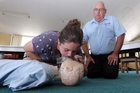 Lucy Roberts, a student from Havelock North and a Waimarama Surf Club rookie, learns first aid from Meditrain's John Mitchell. Photo / Paul Taylor Lucy Roberts, a student from Havelock North and a Waimarama Surf Club rookie, learns first aid from Meditrain's John Mitchell. Photo / Paul Taylor