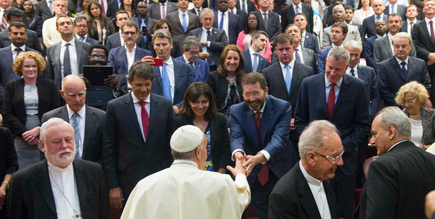 Pope Francis greets Rome Mayor Ignazio Marino as he meets mayors during a conference on Modern Slavery and Climate Change at the Vatican. Photo / AP