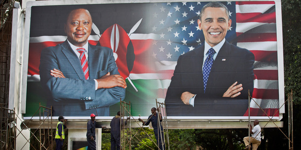 Workers finish installing a large billboard showing Kenya's President Uhuru Kenyatta and President Barack Obama in downtown Nairobi. Photo / AP