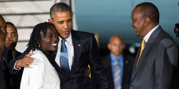 President Barack Obama hugs his half-sister Auma Obama at Kenyatta International Airport. Photo / AP